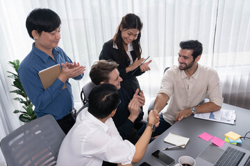 Fototapete - Diverse group of office employee worker shake hand after making agreement on strategic business marketing meeting. Teamwork and positive attitude create productive and supportive workplace. Prudent