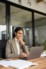 vertical portrait middle eastern woman using computer technology app for work online.focused profess
