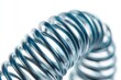 © Ева Поликарпова - Close-up shot of a metal spring on a white background