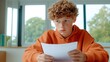 © Y_Malashkevych - A teenage boy appears confused as he examines his exam paper in a bright classroom. He is focused and deep in thought trying to find the answers but struggling to understand the questions posed