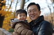 © Web - Joyful Moments: Asian Father and Son Enjoying Outdoor Fun in the Park