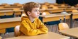 © Y_Malashkevych - In an empty classroom a young boy sits alone at a desk with a sad expression. His body language conveys feelings of isolation and sadness related to bullying experiences in school