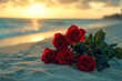 © Ева Поликарпова - A bouquet of red roses sitting on the edge of a sandy beach, perfect for romantic getaway or wedding inspiration