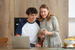 © Pixel-Shot - Young couple with laptop and tablet computer shopping online in kitchen