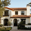 © GICU - a california spanish style home exterior with a red tile roof white stucco black trim and aged stone