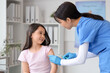 © Pixel-Shot - Little Asian girl receiving vaccine in clinic