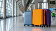 © A-TiMe  - Travel essentials colorful luggage collection at an airport terminal product display in modern environment