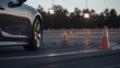 © Cozirlax - Car Navigating Sharp Curve in Outdoor Track During Sunset with Traffic Cones and Dramatic Lighting