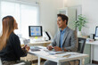© amnaj - Asian businesspeople discussing during meeting in modern office