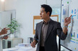 Asian businessman presenting financial data analysis during a meeting