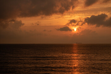 Wall Mural - The morning or evening orange sun over the sea.