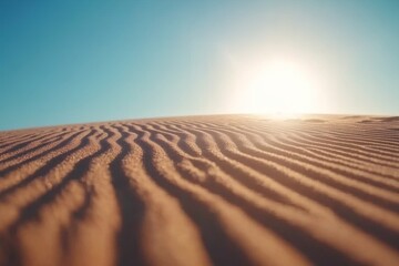 Aufkleber - Soft sunlight highlights the intricate ripples of a large sand dune under a clear blue sky, showcasing the tranquil beauty of the desert environment