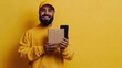 © indirah - Smiling delivery man holds package, phone, yellow background