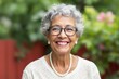 © Pixels Hunter - Elderly woman smiling outdoors with greenery background.
