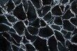© Oleksandr - top-down perspective capturing intricate arrangement of ice cracks forming irregular geometric patterns over dark reflective