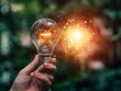 © lareyna - glowing light bulb, bright light, hand holding, innovative concept, close-up