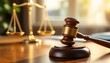 © Dmitry - Wooden judge gavel and golden scales of justice on brown table in courtroom. Legal system, law and order concept. Attorney office equipment with space for text