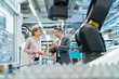 © Westend61 - Businessman and businesswoman talking in a modern factory hall