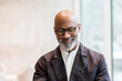 © Westend61 - Portrait of bald mature businessman with grey beard wearing glasses