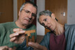 © Westend61 - Happy senior couple playing dexterity game at home