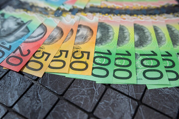 Wall Mural - AUD different polymer color denominations Australian dollar bills in dark background