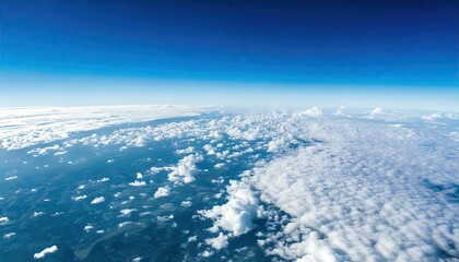 bright cloudy sky view from airplane. White clouds on blue sky background close up, cumulus clouds high in azure skies, beautiful aerial cloudscape view from above.