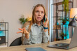 © Andrii Iemelianenko - Nervous angry female manager quarrelling smartphone call online at home office desk. Businesswoman talking aggressively mobile phone call. Stressed annoyed girl scolding subordinates, hotline service.
