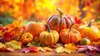 © chaowalit - Autumnal pumpkins and gourds on fallen leaves.  Rustic harvest decor for fall.