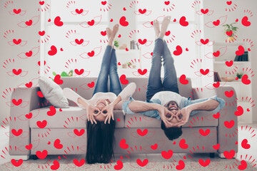 Wall Mural - We go crazy and have fun together Beautiful cheerful delightful humorous couple of two lovers clothed in casual denim outwear, demonstrating binoculars using hands, lying upside-down