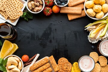 Wall Mural - Frame with a variety of beer snacks on a black background. Top view