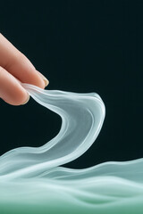 Poster - A detailed perspective shot where the handâ€™s motion on a green pump creates a ribbon of silky whit