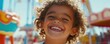 © Влада Яковенко - Joyful mixed-race child smiling at sunny amusement park carnival