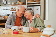 © Rido - Lovely old couple embracing and smiling in kitchen