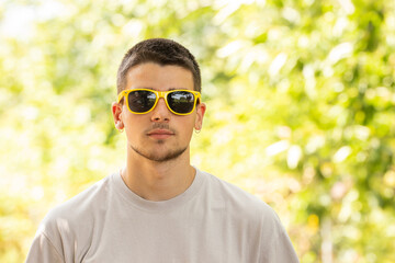 Wall Mural - portrait of young man with sunglasses outdoors