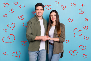 Poster - Photo of sweet charming young lady guy wear green shirts holding arms smiling isolated blue color background