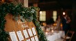 © SERHII - Wedding reception seating chart with greenery in rustic setting
