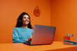 © Jacob Lund - Happy support agent working on laptop in colourful office with bold colour blocking