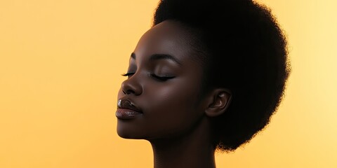 Canvas Print - Young woman with textured hair in profile against a warm yellow background, eyes closed, serene expression highlighting natural beauty.