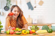 © Prapol Srinakara - portrait freshy young asian woman having fun in the kitchen,hand holding ripe tomato for cook,healthy food,nutrition,vitamin,beauty,health
