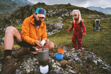 family camping kitchen - father and child on picnic in mountains travel lifestyle dad and kid cookin