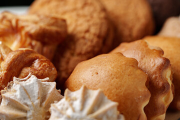 Wall Mural - Freshly baked cookies and pastries arranged on a plate in a cozy kitchen setting during afternoon tea