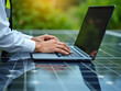 © Rysak - person working on a laptop computer placed on solar panels