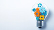© Fareedoh - An illuminated light bulb filled with colorful gears representing creativity and innovation.