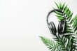 © Sergey - Headphones resting on green tropical leaves creating minimalistic music concept