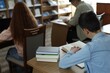 © New Africa - Students studying at desks in public library