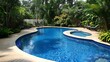 © Alexander - New salt water swimming pool with tanning ledge and steps enclosed by white iron fence and surrounded by lush tropical landscaping