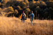 © Zoran Zeremski - Rear view of two woman hiking at top of the hill at meadow.