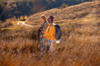 © Zoran Zeremski - Two smiling woman hiking at top of the hill at meadow.