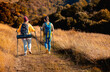 © Zoran Zeremski - Rear view of two woman hiking at top of the hill at meadow.