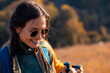 © Zoran Zeremski - Portrait of smiling woman hiking with her friend at top of the hill at meadow.